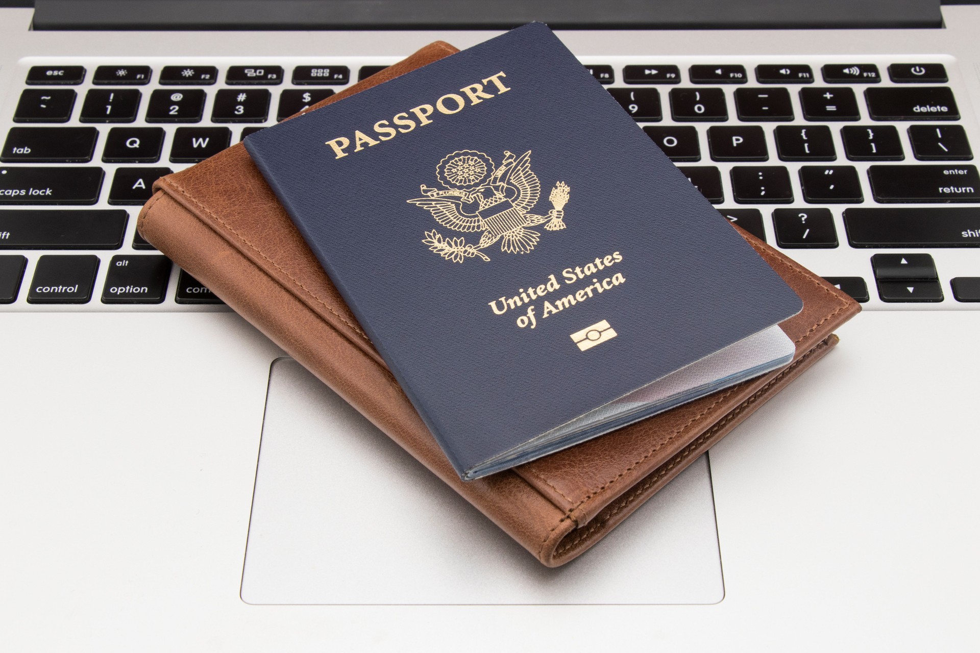 USA passport on laptop keyboard